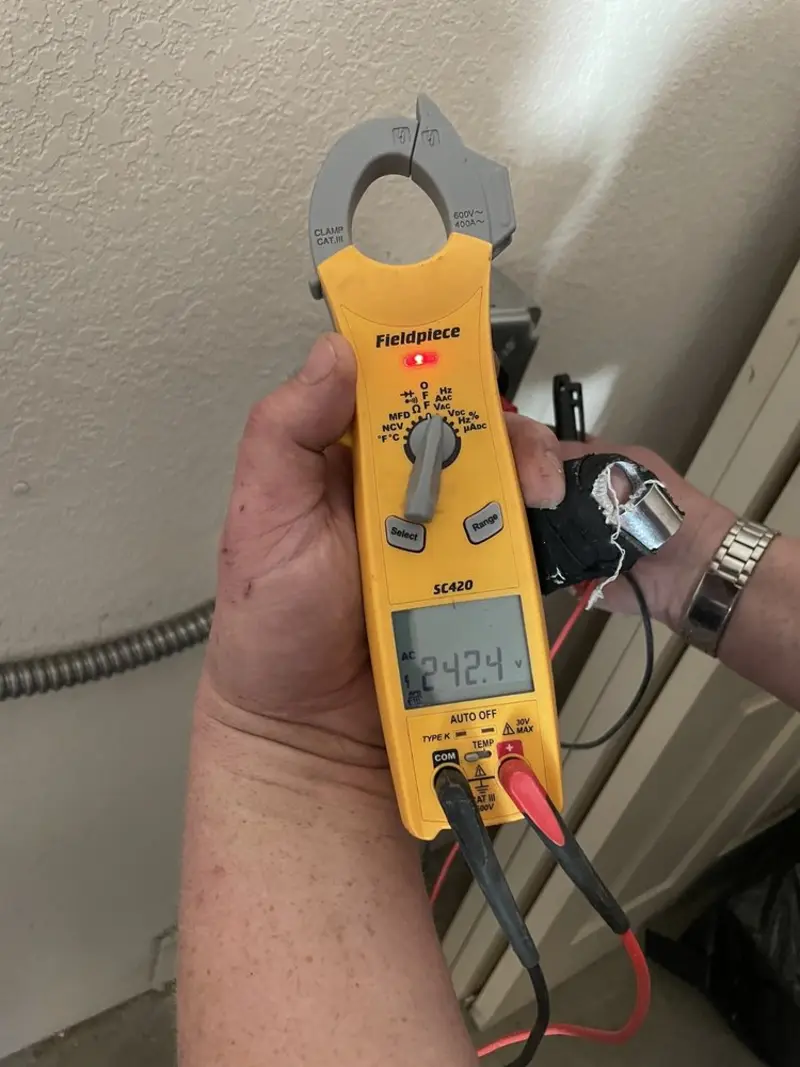 Voltage testing with clamp meter during Recessed Lighting Installation in Sandy Springs